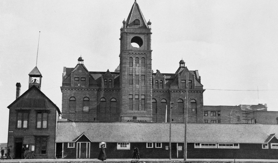 The old frame City Hall in front of the new sandstone City Hall, Calgary, 1910